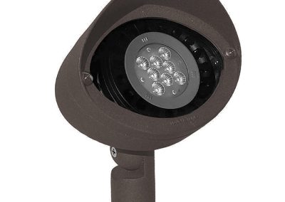 The MaxFlood is a brown outdoor LED landscape spotlight featuring a round head, visible lens with multiple LEDs, and an adjustable mounting base.