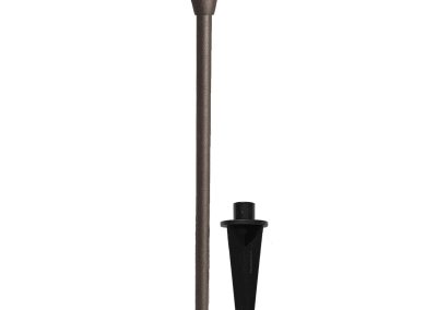 The Commander is a brown outdoor pathway light featuring a round, angled shade and comes with a black plastic ground stake.