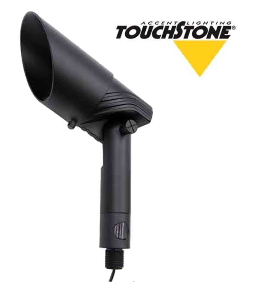 The ColorFlood black spotlight fixture features a cylindrical shape, adjustable elements, and a pointed shade. The "Touchstone Accent Lighting" logo with a yellow triangle design is in the upper right corner.