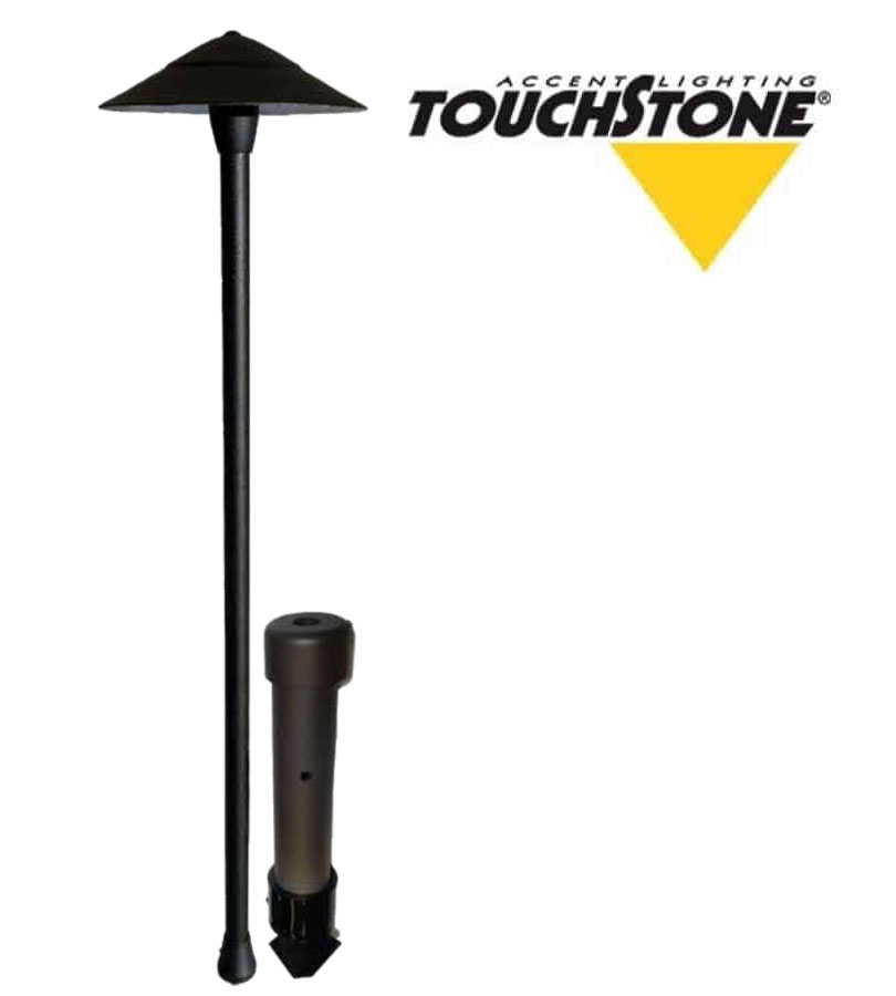 The Commander outdoor path light features a sleek black design, accompanied by a stake for ground installation. The Touchstone logo is displayed in the upper right corner.